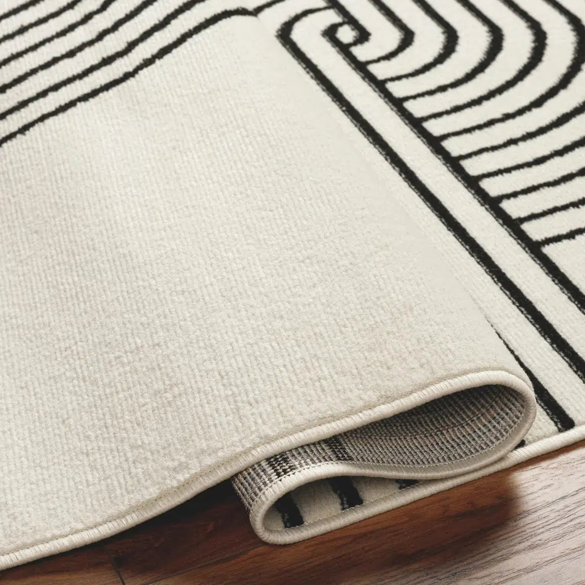 Tapis SURYA Constance rétro, motif arcs concentriques, blanc cassé et noir, vue 3