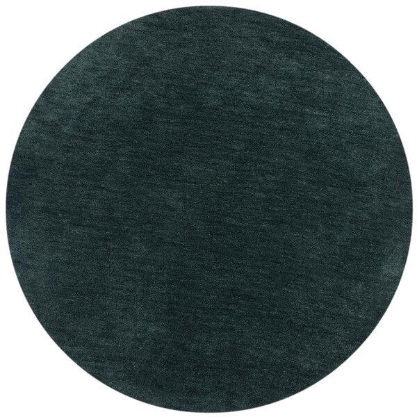 tapis Isla rond couleur vert bouteille sur un fond blanc